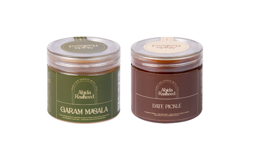 Two jars of Abida Rasheed, one labeled 'Garam Masala' and the other 'Date Pickle', on a white background.