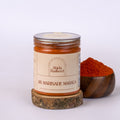 Jar of Abida Rasheed AR Marinade Masala with a wooden bowl of spices on a white background