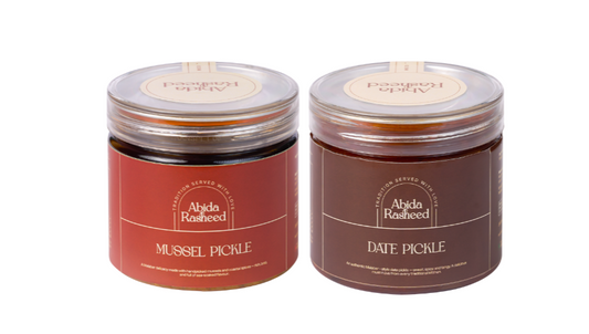 Two jars of pickles with labels on a white background